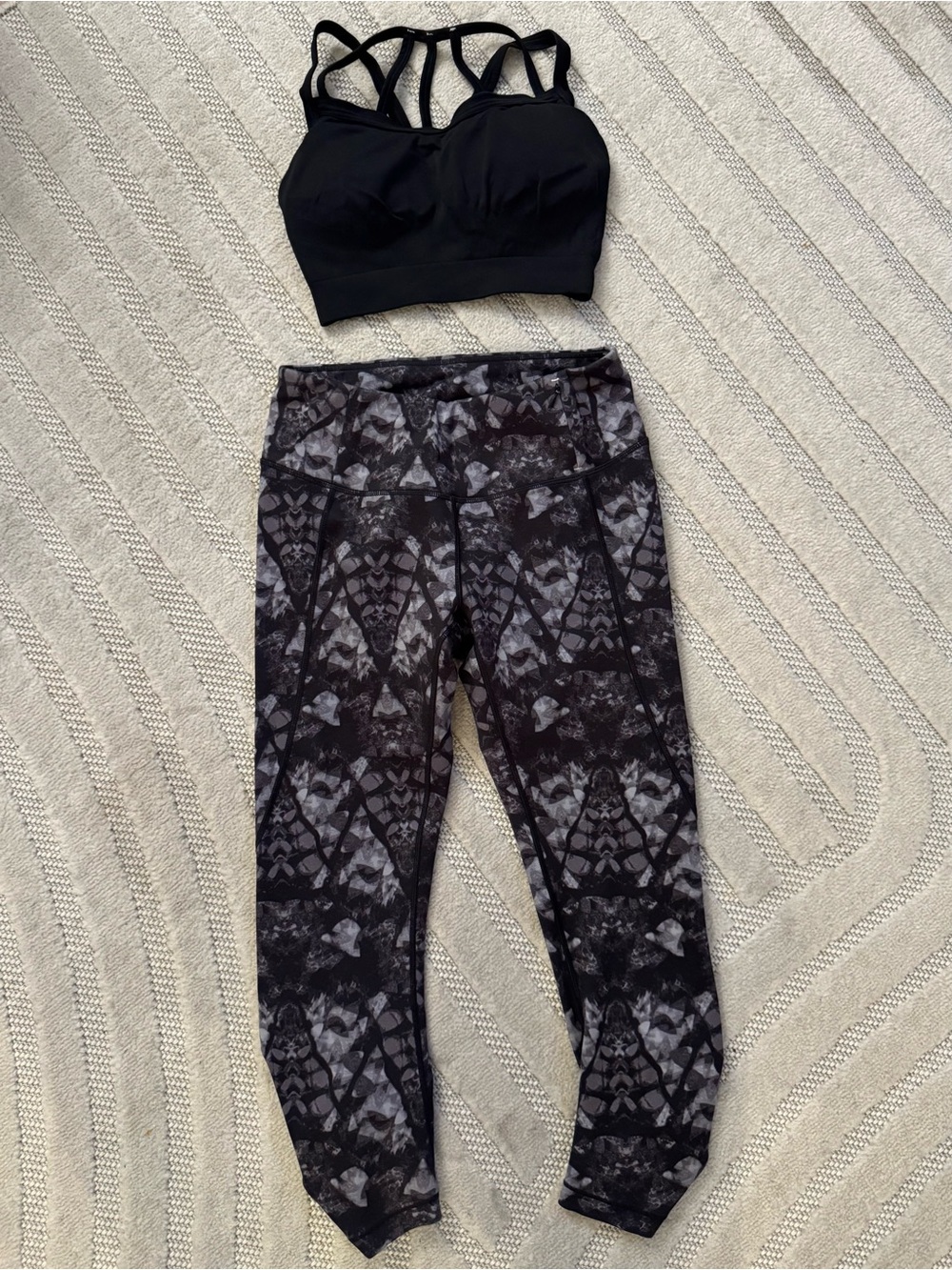 CALIA Black Sports Bra and Black and Gray abstract print capri length leggings.
